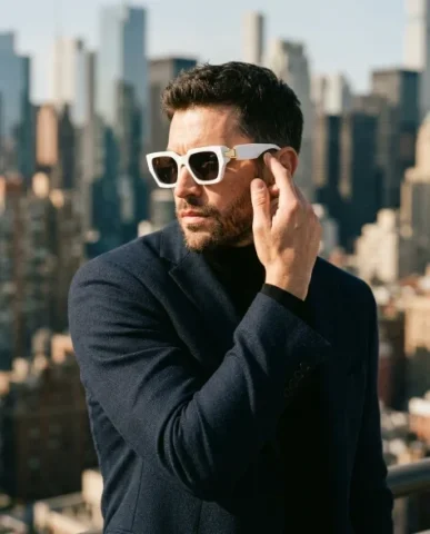 Fashion Campaign — Low-Angle Statement Glasses 5 — Nano Banana AI Prompt: Hyper-realistic fashion campaign portrait from a high camera angle looking down....