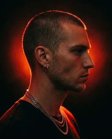 Fashion Portrait — Red Light Close-Up 5 — Nano Banana AI Prompt: Hyper-realistic fashion editorial profile portrait facing camera-right. A man wi...