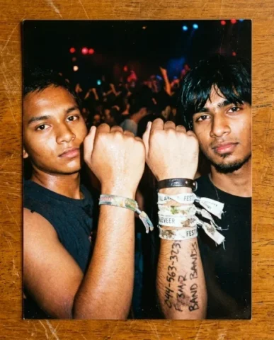 Nostalgic Flash — 2000s Concert / Music Festival 5 — Nano Banana AI Prompt: The photo is shot from below by a South Asian guy with shaggy black hair and a g...