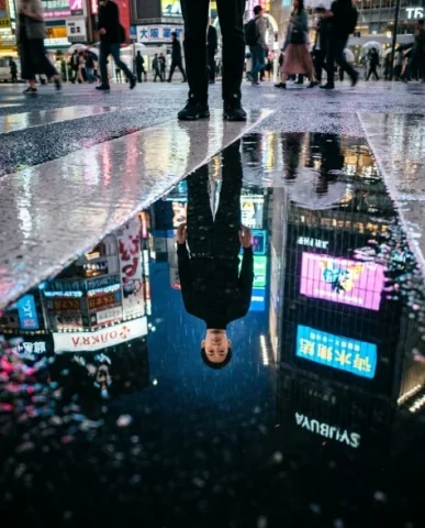 Frozen in Motion — Tokyo Crossing 6 — Nano Banana AI Prompt: Cinematic side profile shot of a person with distinctive features standing at a...