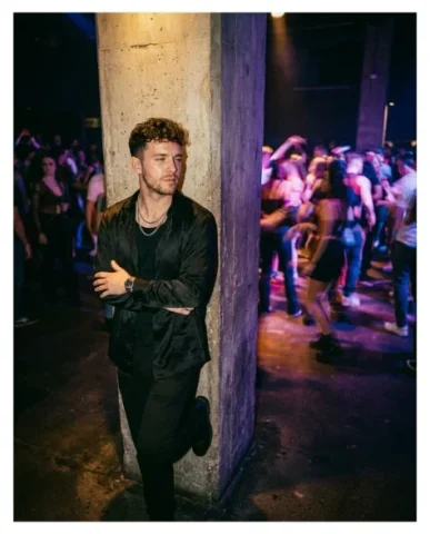 Frozen in Motion — Dance Floor 1 — Nano Banana AI Prompt: Cinematic low-angle shot of a person with distinctive features standing perfectl...