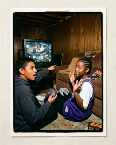 Gaming with [Character] — N64 Era, 1997 6 — Nano Banana AI Prompt: Two friends passed out asleep on the brown corduroy couch in a wood-paneled base...