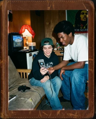 Gaming Buddies — PS2 Era, 2004 4 — Nano Banana AI Prompt: Close-up of the small TV balanced on a mini-fridge in a college dorm room showin...