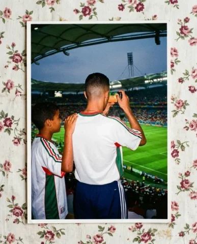 Stadium — World Cup, 1998 5 — Nano Banana AI Prompt: Close-up portrait of two friends — a young person with short dark hair and warm...