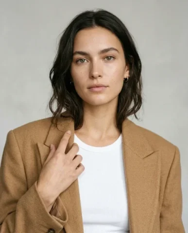 Minimalist Fashion Studio Portrait 3 — Nano Banana AI Prompt: The soft neutral seamless backdrop in light grey provides clean negative space a...