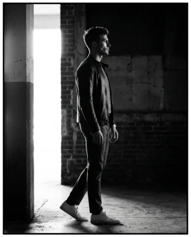 High-Contrast Black and White Cinematic Portrait 6 — Nano Banana AI Prompt: The subject stands centered in the frame facing the camera directly, both hands....