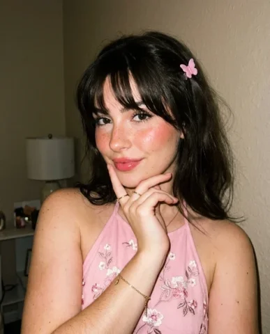 Soft Flash Coquette Portrait with Butterfly Clip 5 — Nano Banana AI Prompt: Her minimal jewelry — a thin ring and small bracelet — catches the flash light....