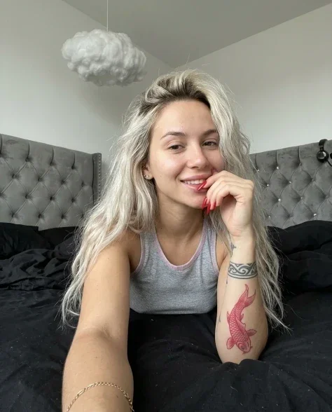 Casual Smartphone Photo of Tattooed Woman in Bedroom 1