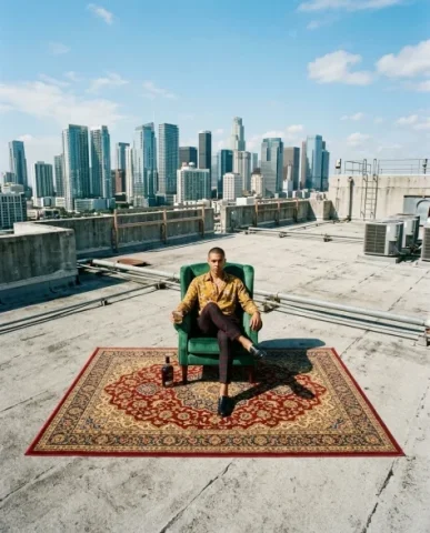 Rooftop Power Editorial with Armchair and Cityscape 7 — Nano Banana AI Prompt: Highly stylized editorial vertical photo of a confident young man sitting in a l...
