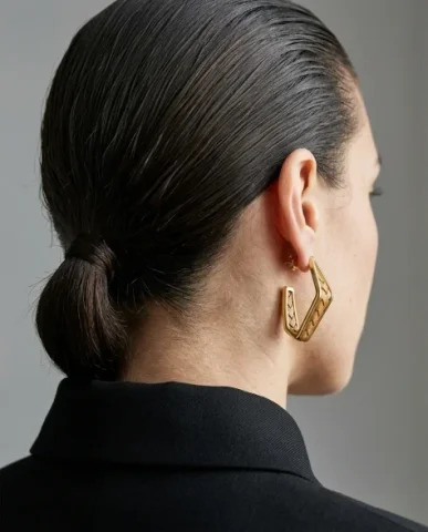 Sculptural Bold Earring Minimalist Close-Up Portrait 7 — Nano Banana AI Prompt: Minimalist close-up fashion portrait from behind of a female model wearing a hig...