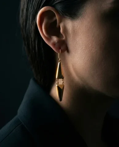 Edgy Smoky Eye Gold Earring Moody Editorial Portrait 3 — Nano Banana AI Prompt: Vertical editorial extreme macro close-up focusing on the gold drop earring. The...
