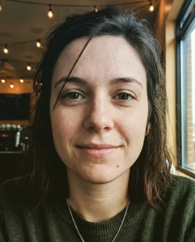 Lo-Fi Authentic Phone Camera Portrait 4 — Nano Banana AI Prompt: Tight lo-fi close-up of the same woman's face with a natural half-smile and unre...