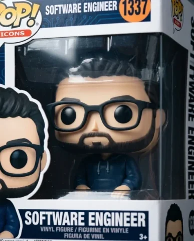 Funko Pop Style Vinyl Figure 2 — Nano Banana AI Prompt: The figure depicts a software engineer character wearing a casual tech startup o...