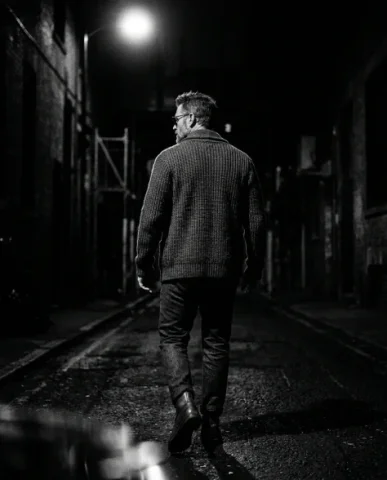 Black-and-White Menswear Editorial — Urban Night 7 — Nano Banana AI Prompt: The thick chunky-knit button-up cardigan fills the frame — the cable knit patter...