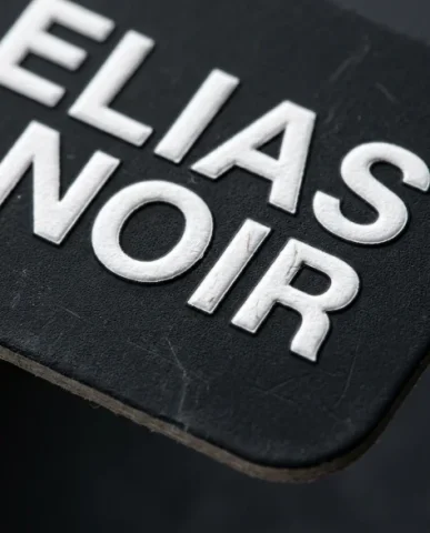 Premium Social Media Profile Card — Editorial Photoshoot 4 — Nano Banana AI Prompt: Extreme macro close-up of the matte-black social media profile card surface, fil...