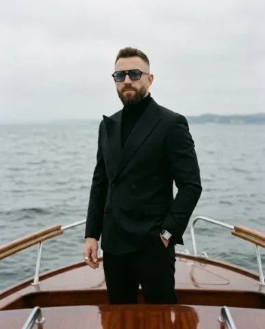 Luxury Menswear Editorial on a Vintage Boat 2 — Nano Banana AI Prompt: An editorial photograph of an adult male with a styled fade haircut and a neatly...