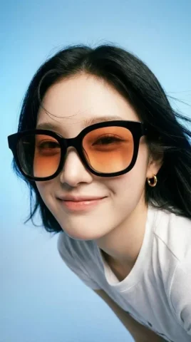 Orange-Lens Sunglasses Studio Portrait — Nano Banana 2 AI Prompt: Photorealistic editorial portrait of a smiling woman using the exact same face f...