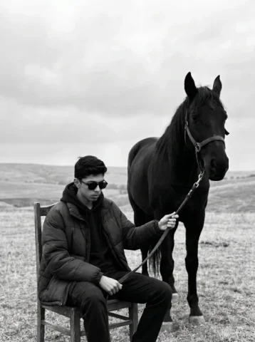 Black-and-White Man and Horse Power Portrait — Nano Banana 2 AI Prompt: { "model": "Nano Banana Pro", "scene": "Open field landscape under an overcast...