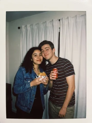 Polaroid Couple Snapshot by White Curtains — Nano Banana 2 AI Prompt: { "type": "image_generation_prompt", "style": "Polaroid-style candid photograp...
