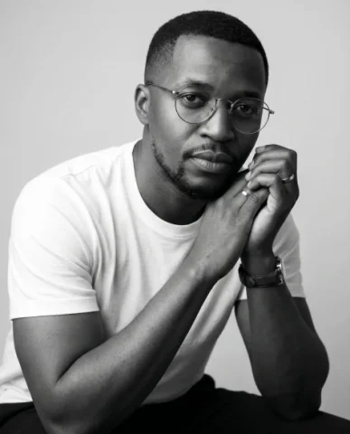 Black and White Thoughtful Studio Portrait — Nano Banana 2 AI Prompt: high-end black and white indoor studio portrait of the same person as the refere...