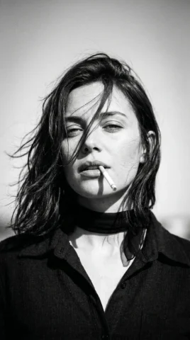 1970s Windswept Black-and-White Portrait — Nano Banana 2 AI Prompt: Create a 1970s black-and-white close-up portrait in a windswept outdoor setting,...