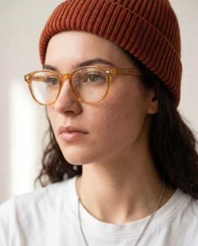 Amber Glasses Beanie Close-Up Portrait — Nano Banana 2 AI Prompt: Use the uploaded reference image only for preserving the subject's facial identi...