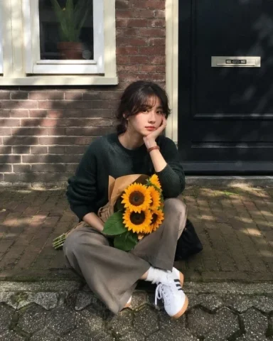 Sunflower Sidewalk Lifestyle Portrait — Nano Banana 2 AI Prompt: Ultra realistic lifestyle portrait of a beautiful young East Asian woman sitting...