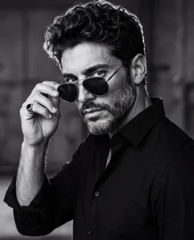 High Contrast Male Portrait — Nano Banana 2 AI Prompt: A cinematic high-contrast black-and-white portrait captured from a three-quarter...