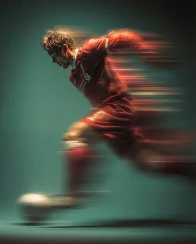 Red Soccer Player Panning Kick — Nano Banana 2 AI Prompt: Panning shot of a mysterious soccer player in red proffesional soccer jearsy mid...