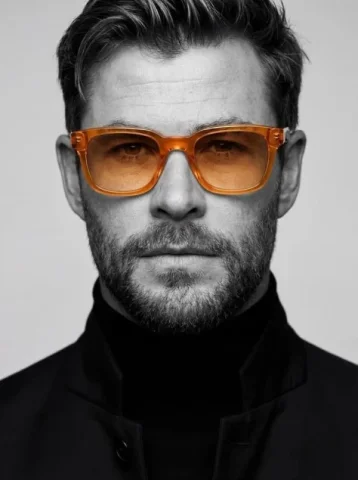 Black-and-White Male Headshot With Amber Glasses — Nano Banana 2 AI Prompt: Ultra-realistic studio portrait of a man, close-up headshot, centered compositio...