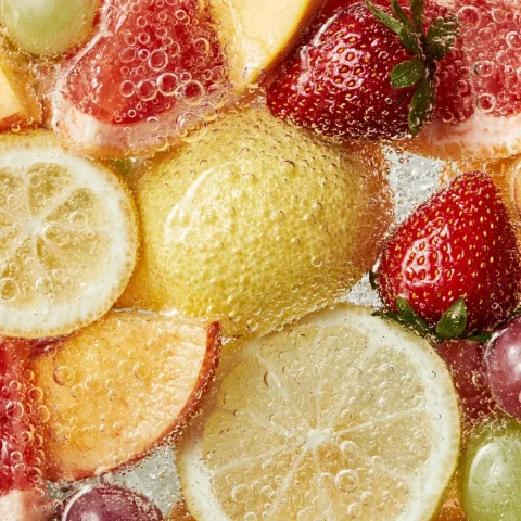 Fruit Bubbles in Sparkling Water — Nano Banana 2 AI Prompt: Lemon, peach, grapefruit, strawberry, grapes soaked in sparkling water, large an...