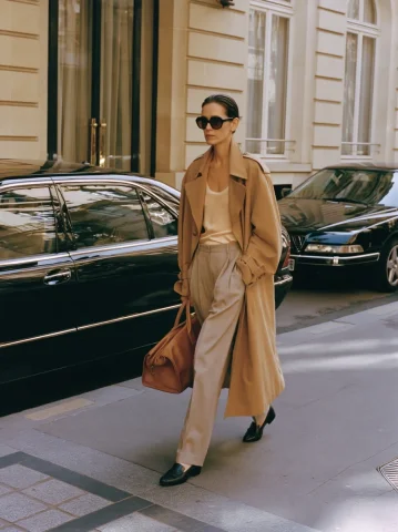 Dawn Hotel Departure in Camel Trench — Nano Banana 2 AI Prompt: Off Duty THE DEPARTURE. woman leaving luxury hotel at dawn, oversized camel tren...