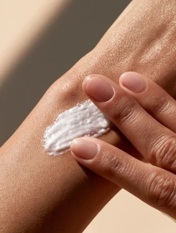 Silky Body Cream Application — Nano Banana 2 AI Prompt: Slow realistic body cream application. A woman's hand gently spreads a rich whit...