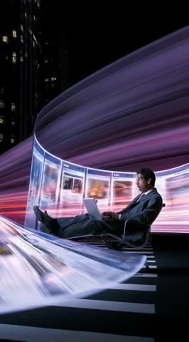 Businessman Amid Glowing Facebook Pages — Nano Banana 2 AI Prompt: a full shot of a hispanic man in a business suit sitting on an office chair with...