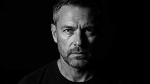Classic Rembrandt Lighting Portrait — Nano Banana 2 AI Prompt: Photorealistic black and white cinematic portrait of a rugged middle aged man wi...