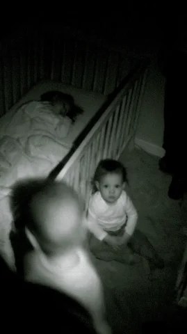 Baby Monitor Footage — Nano Banana 2 AI Prompt: grainy monochrome baby monitor footage, night vision security camera view of a d...