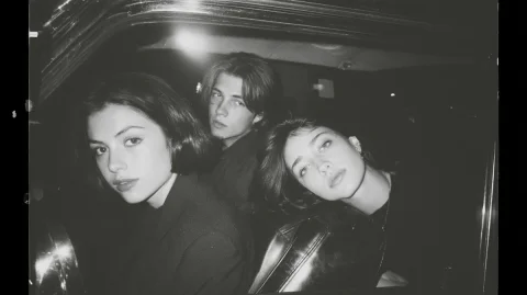 Midjourney Top Poster #42 — Midjourney v6 AI Prompt: Early 2000s indie magazine editorial, two young adults sitting side by side in t...