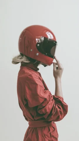 1960s Motorsport Fashion — Nano Banana 2 AI Prompt: 1960s retro motorsport fashion editorial photograph, blonde woman shown from beh...