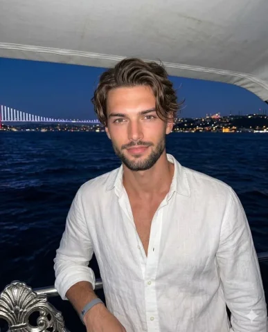 Profile / Avatar - Night Nautical Lifestyle Portrait — Nano Banana 2 AI Prompt: A confident young adult male in his late twenties stands facing the camera with...