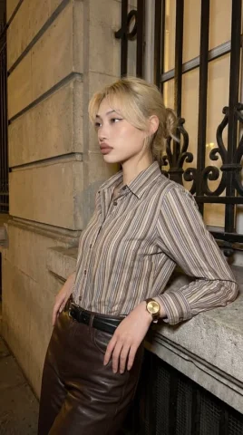 Urban Night Side Profile — Nano Banana 2 AI Prompt: A medium shot of a stylish young woman with blonde hair styled in a loose, casua...