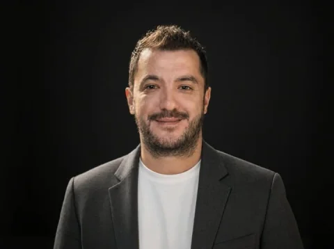 Dark Studio Career Portrait — Nano Banana 2 AI Prompt: A polished studio head-and-shoulders LinkedIn profile portrait of a man centered...