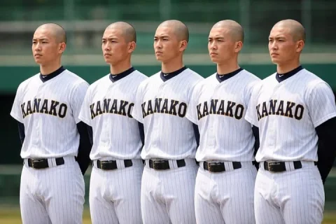 Identical Baseball Players Lineup — Nano Banana 2 AI Prompt: A realistic sports photograph of exactly 5 identical young Asian men standing in...