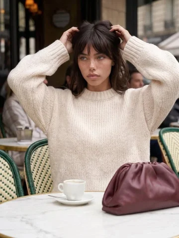 Parisian Cafe Freckles Cream Knit Sweater Editorial Portrait — Nano Banana 2 AI Prompt: Gemini Nano Banana Pro Prompt: "Ultra-realistic portrait of a young woman sittin...