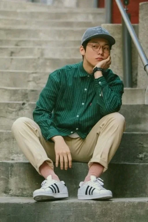 Pensive Young Man on Concrete Stairs