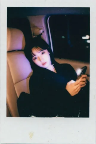 Vintage Polaroid K-Pop Girl Car Backseat Melancholic Night Portrait — Nano Banana 2 AI Prompt: A vintage Polaroid-style close-up photograph of a k-pop girl sitting in the back...