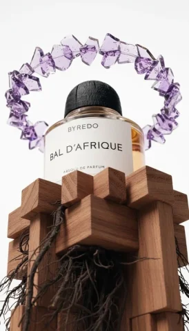 Byredo Perfume Crystal Wood Block Luxury Product Photography — Nano Banana 2 AI Prompt: Luxury product photography of a Byredo Bal d'Afrique Absolu de Parfum bottle pla...