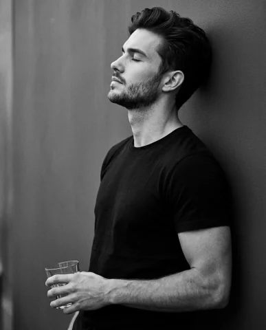 Cinematic Monochrome Side Profile Wall Lean Introspection Portrait — Nano Banana 2 AI Prompt: A cinematic monochrome portrait that keeps my real face exactly intact. I am sho...