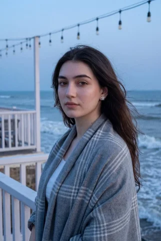 Blue Hour Seaside Terrace Portrait — Nano Banana 2 AI Prompt: Photorealistic portrait of a young woman standing on a seaside terrace during bl...
