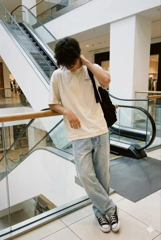 Introspective Boy by Mall Escalator — Nano Banana 2 AI Prompt: Realistic indoor daytime smartphone photo, candid and unposed, captured like a r...