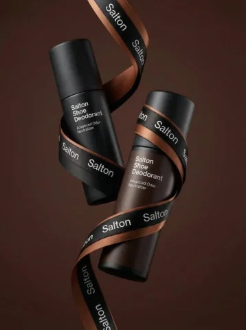 Levitating Shoe Deodorant Premium Product Shot — Nano Banana 2 AI Prompt: A product photo in a premium advertising style. Two tall matte bottles of Salton...